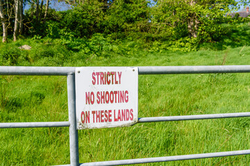 Sign warning "Strictly no shooting on these lands"