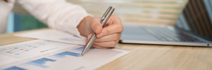 Asian businesswomen are analyzing graphs, financial statistics and calculating corporate returns in private offices, Market research reports and income statistics, Financial and Accounting concept.