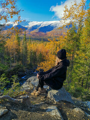 A girl on the background of an autumn Arctic landscape in the Khibiny mountains. Kirovsk, Kola...