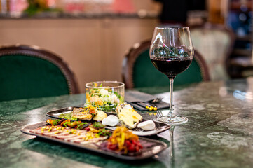 tasting set appetizer food and red wine glass on table