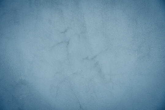 Abstract dark blue background with concrete texture and crack.