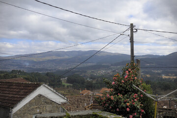 Wind farm from rural area and power lines - A hill, devoid of vegetation, becomes a focal point as...