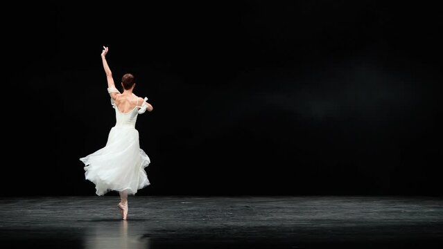 Ballet performance, graceful ballerina in a white tutu dance and perform dramatic choreographic elements on a black background, windy and beautiful dance.