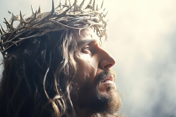 Jesus with bloody crown of thorns on His head over light background. Jesus Christ in agony praying...