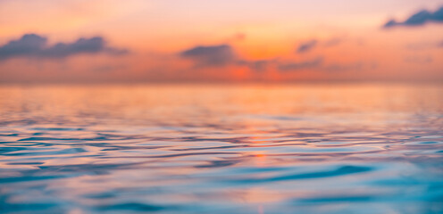 Stunning scenic view of endless ocean water surface with horizon line under defocus bright colorful sunset sky in evening time. Dream inspirational nature pattern, seascape skyline tranquil background
