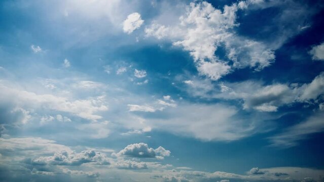 Timelapse of amazing clouds in the sky. Wide cloud Space background with light and grey clouds moving under the sun, time-lapse. Change of weather. Nature, copy space, panoramic cloudspace.
