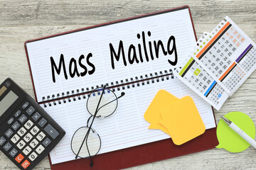 Mass Mailing. notepad with text near calculator and calendar