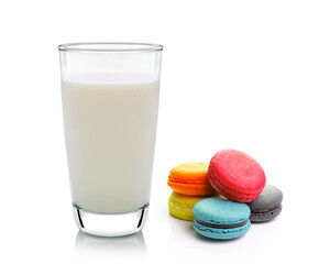 glass of milk and macarons isolated on white background