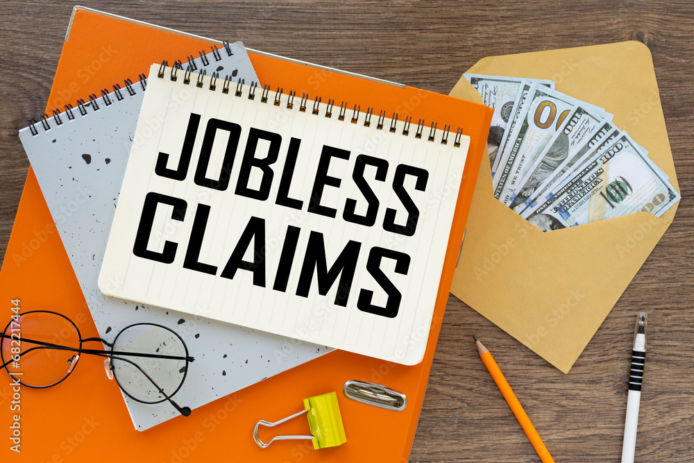 Poster jobless claim top view of text on notepad and money bills in envelope