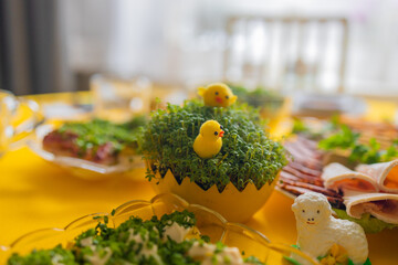 Easter family celebration. Traditional Polish dishes on a wooden table with yellow tablecloth. High...