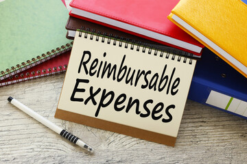 Reimbursable Expenses text concept on sheet with notepad and calculator.