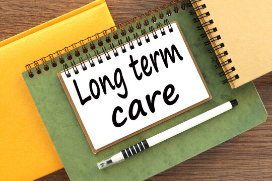 LONG TERM CARE Blank yellow notepad and green notepad on office table