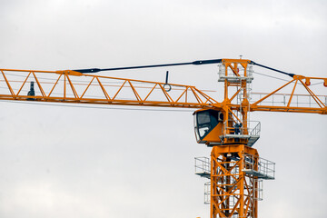 Fragment of a construction crane on a cloudy autumn day