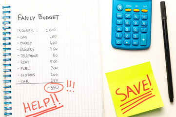 Notebook with budget plan, calculator and Save text. Inflation, price increases and economic difficulties.
