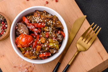 Warm salad with veal, tomatoes, peppers, zucchini, sesame, salt, spices and herbs