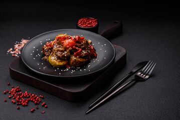 Warm salad with veal, tomatoes, peppers, zucchini, sesame, salt, spices and herbs