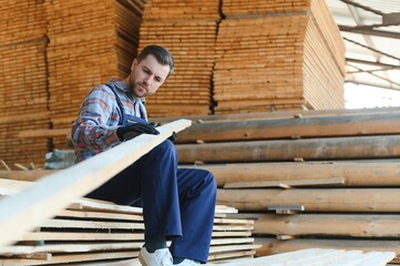 Joiner in uniform check boards on timber mill