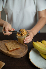 Peanut butter - woman preparing breakfast.