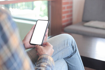 cell phone blank white screen mockup.hand holding texting using mobile on desk at office.background empty space for advertise.work people contact marketing business,technology