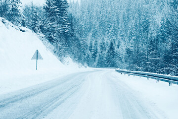 Mountain road landscape covered in snow in winter - 682240250