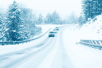Cars driving on mountain road landscape covered in snow in winter  - 682241881