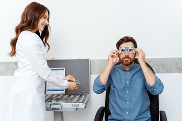 Ophthalmologist checking diagnose eyesight myopia, hyperopia young man