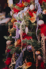 Christmas fir tree decorations with red and gold baubles. New Year celebration concept. Copy space.