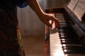 a woman plays the piano. selective focusing