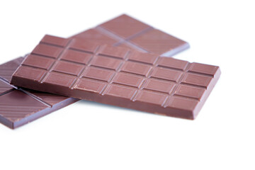 Chocolate bar, studio candy and sugar sweets for delicious temptation, wellness or tasty dessert treat, cacao slab or snack. Unhealthy junk food, product quality and premium cocoa on white background