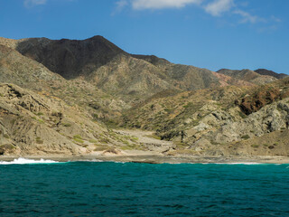 Landscape from the sea of Marguerite island coast over the pacific ocean volcanic rocks in baja...