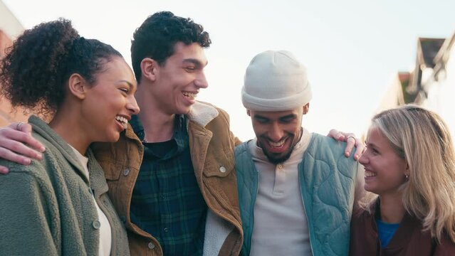 Portrait of smiling multi-cultural group of 20 year old friends hanging out together in urban setting - shot in slow motion