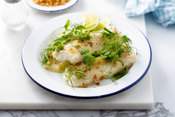 Baked white fish filet with green pea and lime - obrazy, fototapety, plakaty