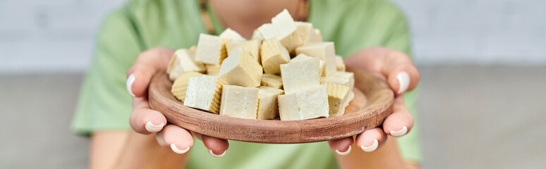 partial view of woman with delicious tofu cheese, horizontal banner of vegetarian dietary choices