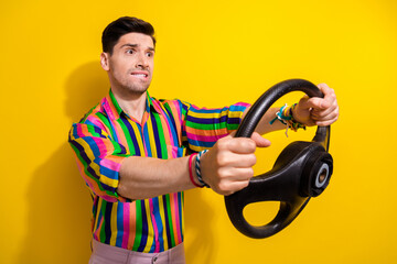 Photo of anxious stressed guy biting lips hold steering wheel excited drive in city with big...