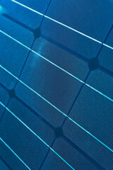 A solar cell pattern close up. Green energy and sustainable electricity resource concept. Solar panels blue background. Photovoltaic modules for renewable energy
