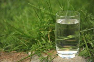 Pouring fresh water on stone surface outdoors, space for text