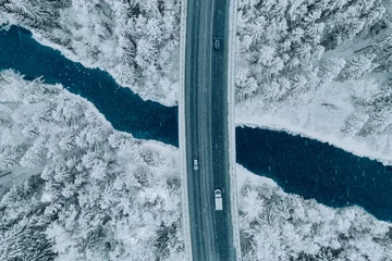Keuken spatwand met foto Aerial top view of snow winter road with cars over blue river © nblxer