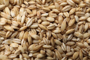 Dry pearl barley as background, top view