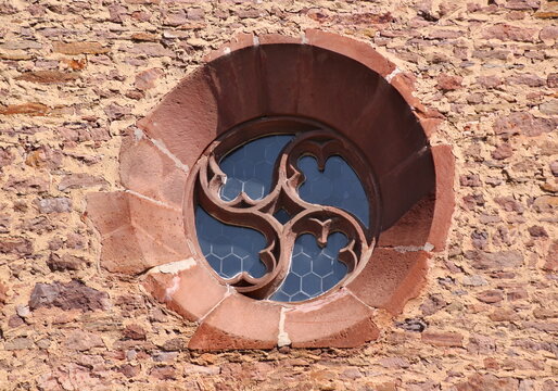 Gothic rose window with mouchette tracery at the medieval village church of Oberndorf (Pfalz) in Germany