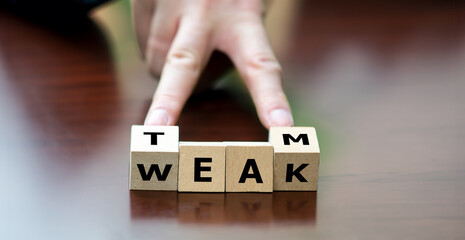  Symbol for being weak without a team. Hand turns wooden cube and changes the word weak to team.