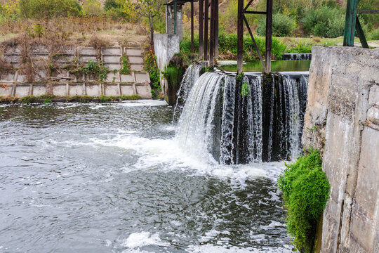 Strong flow of water. Old city wastewater treatment plant in the village of Sataniv, Khmelnitsky region