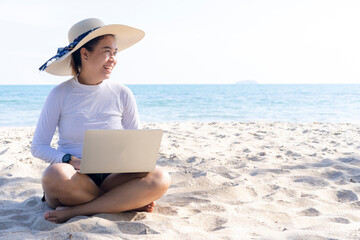 business woman working with laptop by the sea