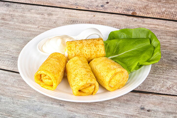 Stuffed pancakes with cream sauce