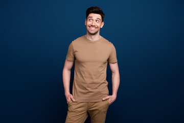 Photo of successful positive man wear beige trendy stylish clothes looking up empty space poster isolated on dark blue color background