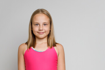 Obraz premium Beautiful kid girl with brown hair and cute smile on white background