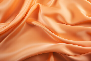 Fototapeta premium Carrot apricot colour silk satin wave drapery abstract background. Flowing fabric material texture concept