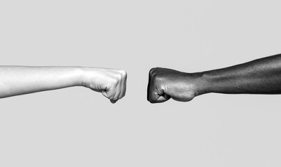 Black African American race male and woman hands giving a fist bump. Friendship, team, good work. Multicultural friends giving fist bump to each other. Black and white