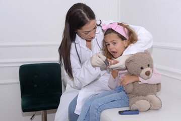 Doctor measures the sugar of a five-year-old child suffering from diabetes