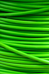 A coil of green electrical cable close-up.