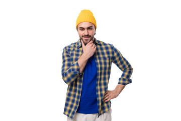 young smart caucasian brunette handsome man with a well-groomed beard and mustache in a plaid shirt on a white background with copy space